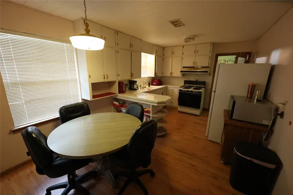 a living room with furniture rug and wooden floor