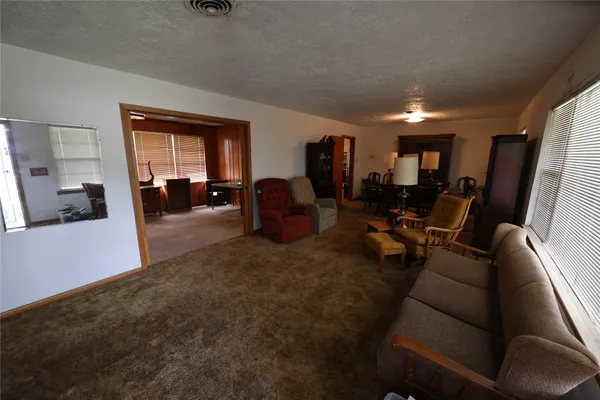 a living room with furniture and large windows