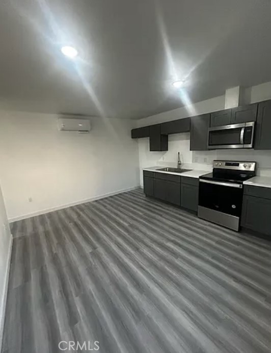 648 East Cerritos Street, Unit 2 Rialto, CA 92376 - Photo 2 of 6 a large kitchen with stainless steel appliances a large counter top