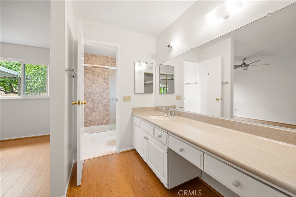 3430 Bahia Place Riverside, CA 92507 - Photo 22 of 34 a bathroom with a granite countertop sink mirror and a bathtub