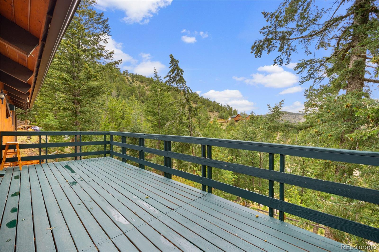 730 Clear Creek Road Evergreen, CO 80439 - Photo 13 of 44 a view of balcony with wooden floor and fence