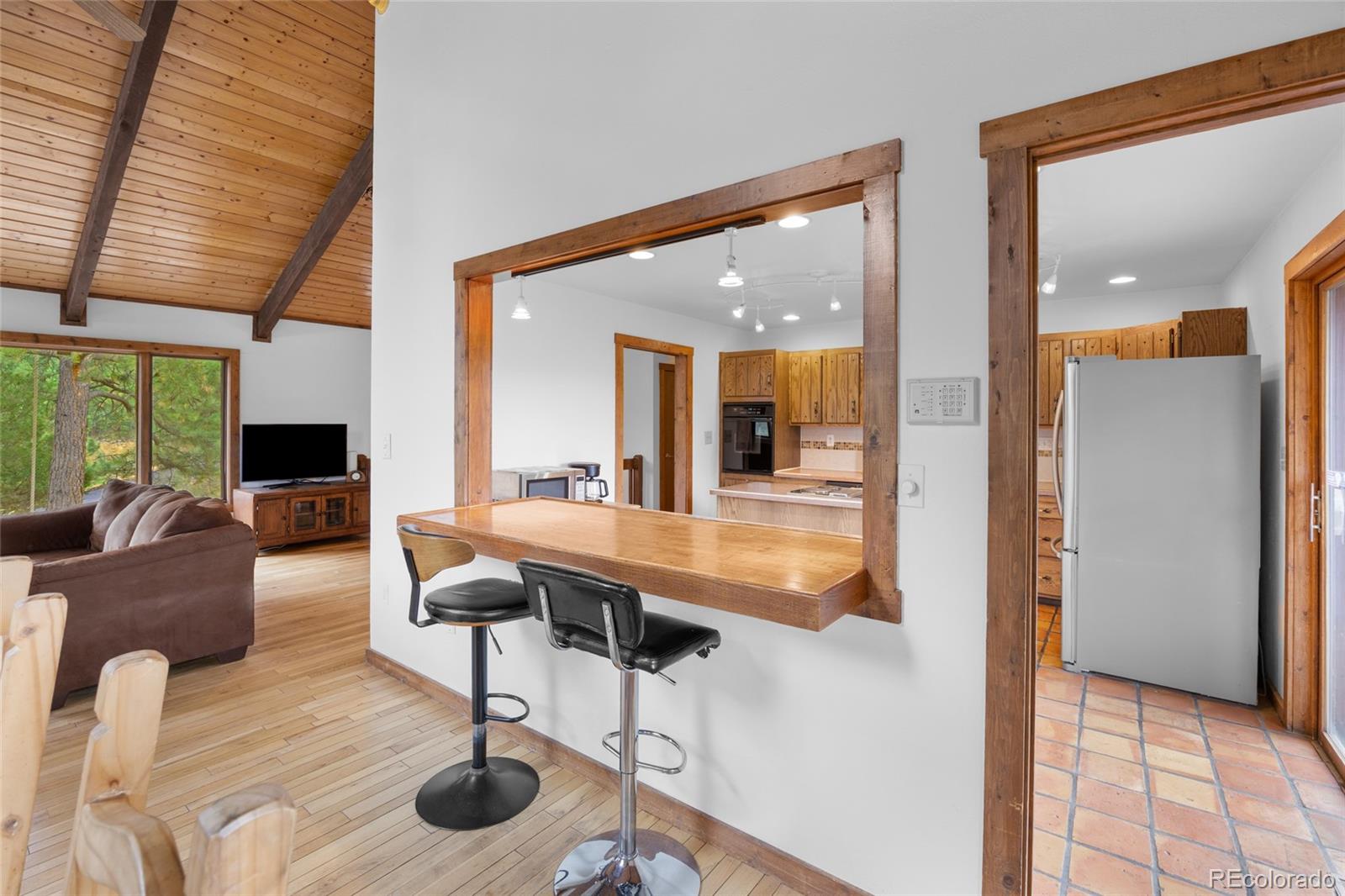 730 Clear Creek Road Evergreen, CO 80439 - Photo 16 of 44 a living room with furniture and a fireplace