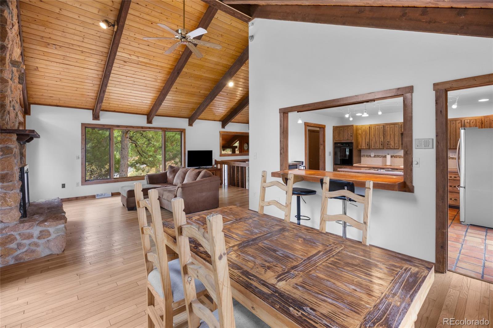 730 Clear Creek Road Evergreen, CO 80439 - Photo 18 of 44 a view of a dining room with furniture window and wooden floor