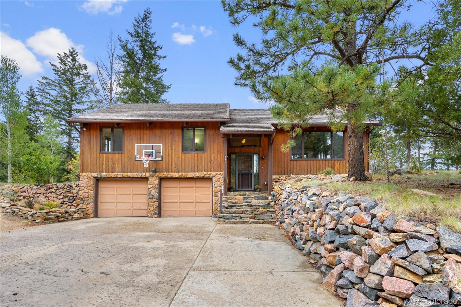730 Clear Creek Road Evergreen, CO 80439 - Photo 2 of 44 a front view of a house with a garden