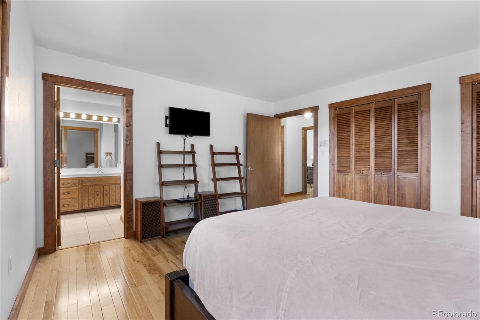 730 Clear Creek Road Evergreen, CO 80439 - Photo 21 of 44 a bedroom with a bed and a television