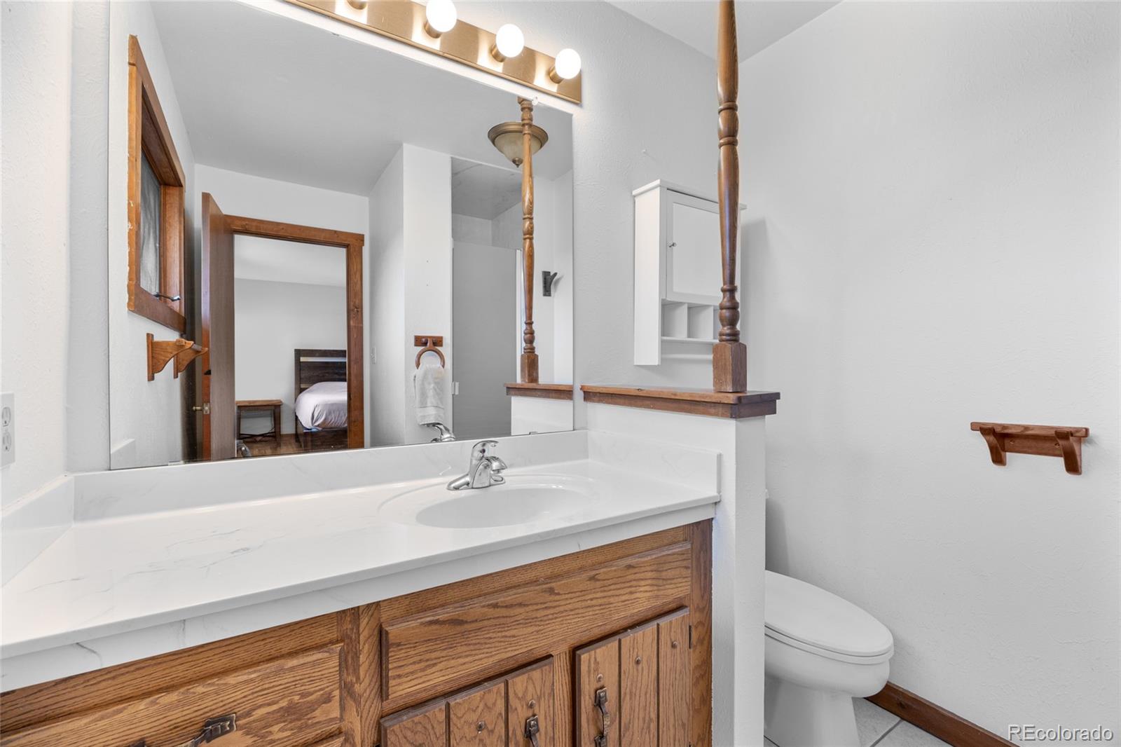 730 Clear Creek Road Evergreen, CO 80439 - Photo 22 of 44 a bathroom with a sink and a mirror
