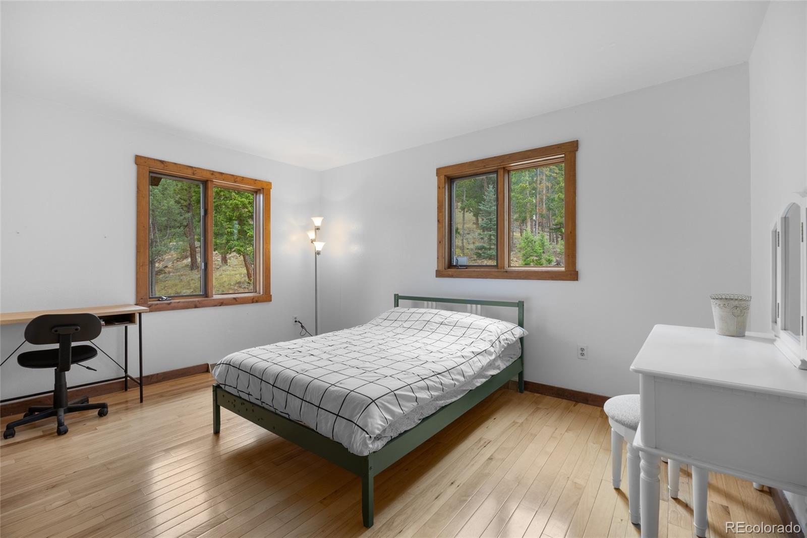 730 Clear Creek Road Evergreen, CO 80439 - Photo 24 of 44 a bedroom with a bed and a window