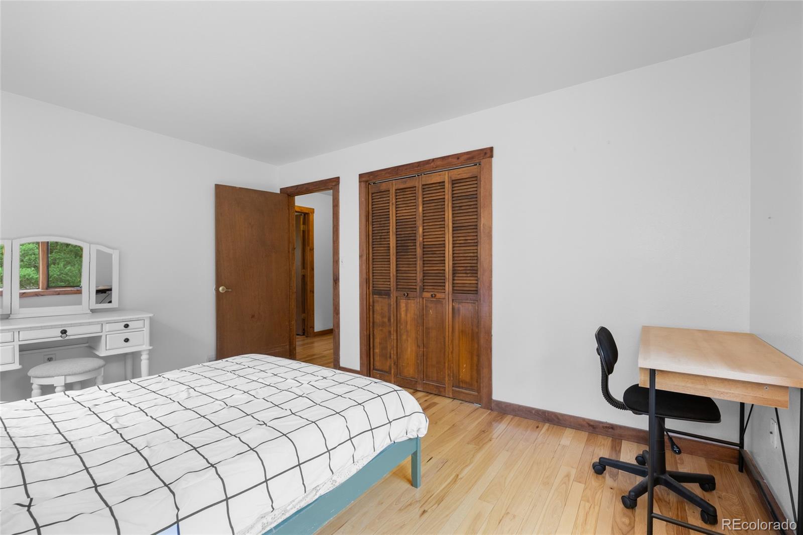 730 Clear Creek Road Evergreen, CO 80439 - Photo 25 of 44 a bedroom with a bed and a chair