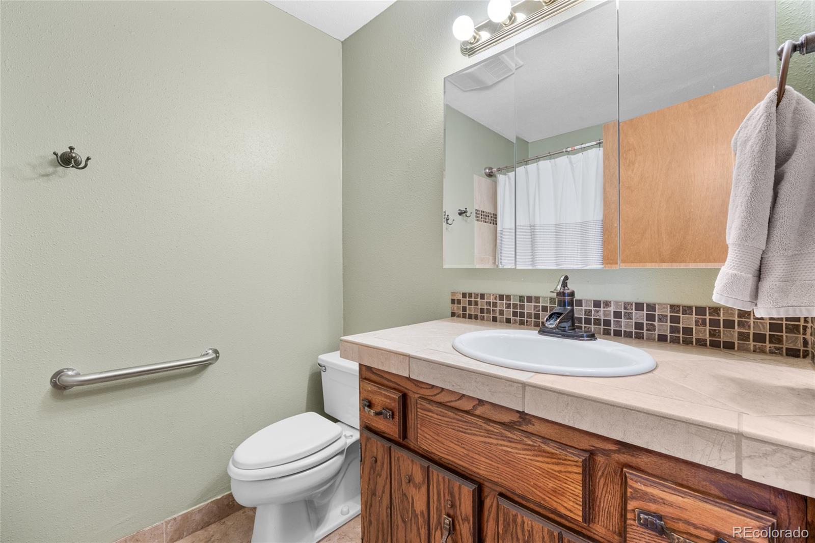 730 Clear Creek Road Evergreen, CO 80439 - Photo 26 of 44 a bathroom with a sink toilet and mirror
