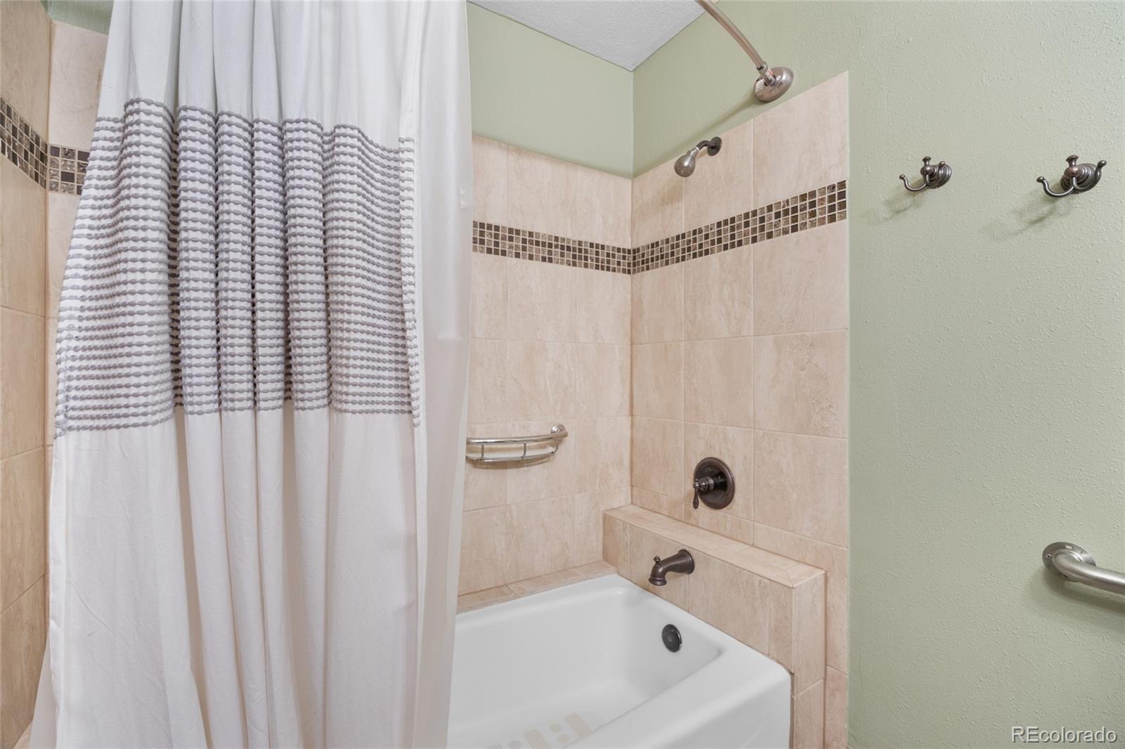730 Clear Creek Road Evergreen, CO 80439 - Photo 27 of 44 a bathroom with a bathtub and shower