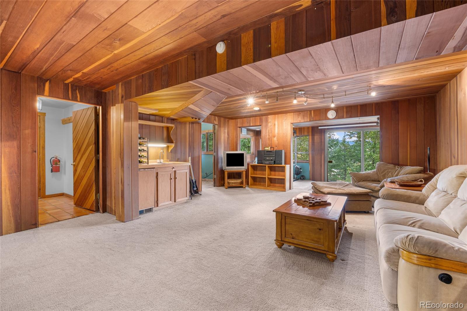 730 Clear Creek Road Evergreen, CO 80439 - Photo 30 of 44 a living room with furniture and large windows