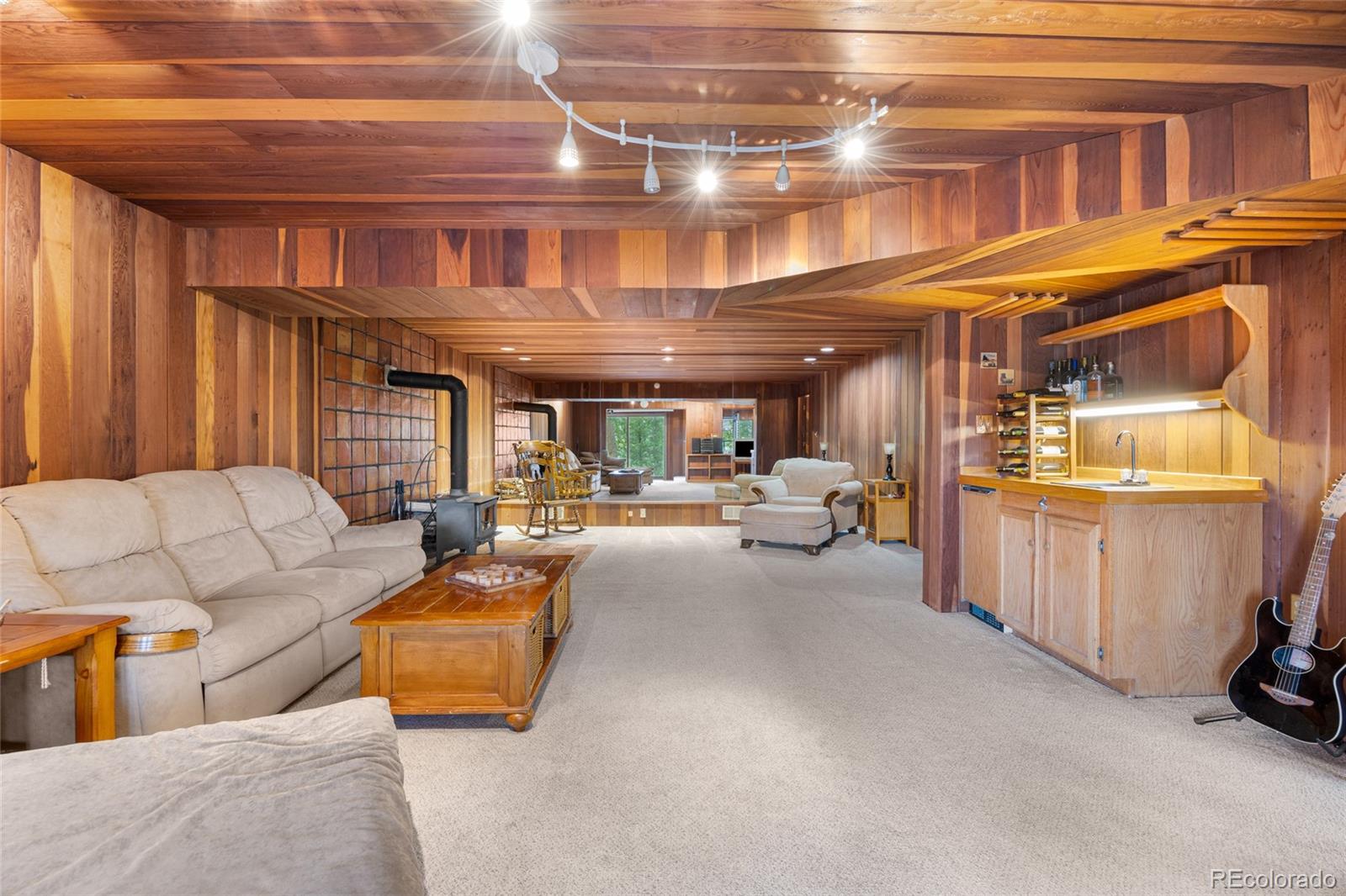 730 Clear Creek Road Evergreen, CO 80439 - Photo 31 of 44 a living room with furniture and a kitchen