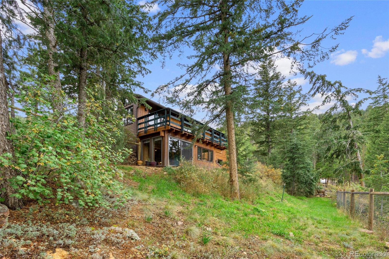 730 Clear Creek Road Evergreen, CO 80439 - Photo 37 of 44 a view of a house with a yard