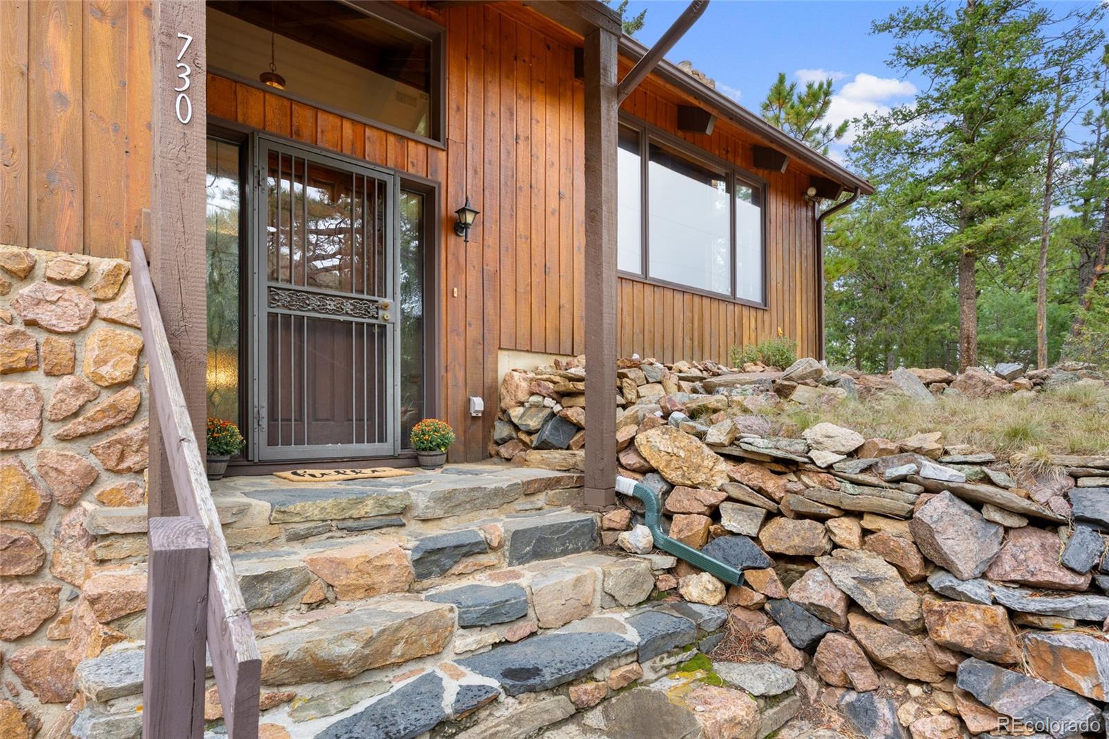 730 Clear Creek Road Evergreen, CO 80439 - Photo 4 of 44 a view of a house with a tree