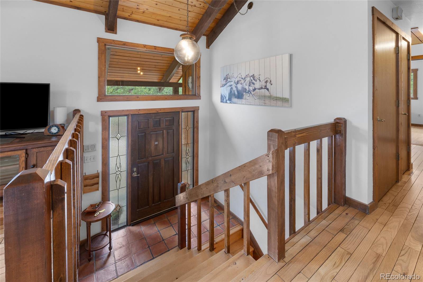 730 Clear Creek Road Evergreen, CO 80439 - Photo 5 of 44 a view of a livingroom with wooden floor and furniture