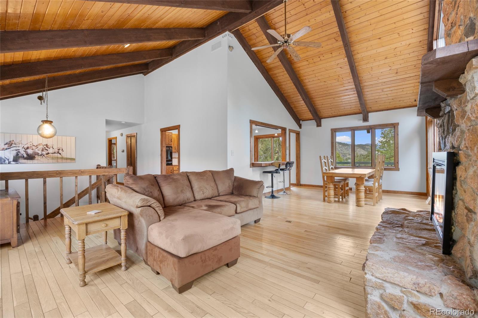 730 Clear Creek Road Evergreen, CO 80439 - Photo 7 of 44 a living room with furniture and a table