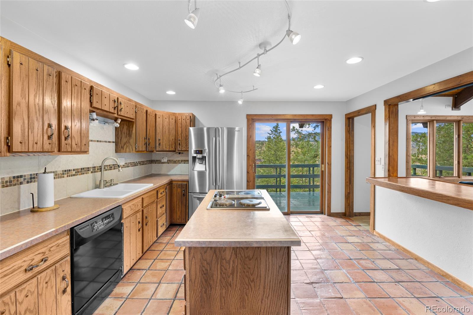 730 Clear Creek Road Evergreen, CO 80439 - Photo 9 of 44 a kitchen with kitchen island granite countertop a stove and a sink