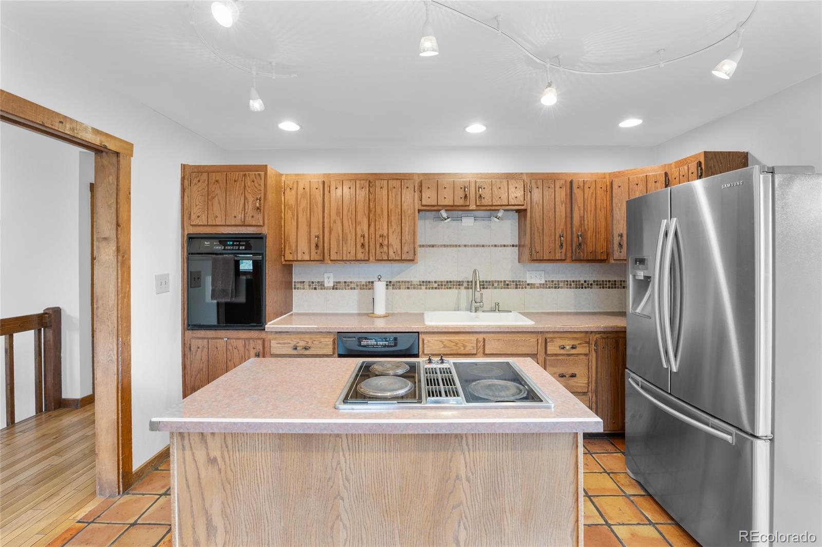 730 Clear Creek Road Evergreen, CO 80439 - Photo 10 of 44 a kitchen with a stove a refrigerator and a sink