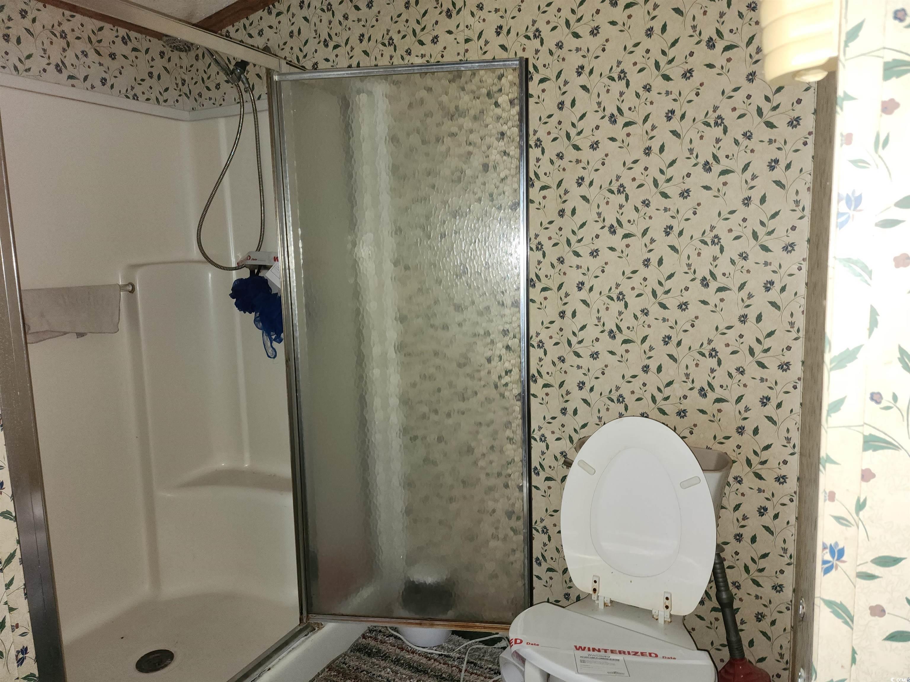 5160 Spring Street Loris, SC 29569 - Photo 16 of 18 Bathroom with an enclosed shower and toilet