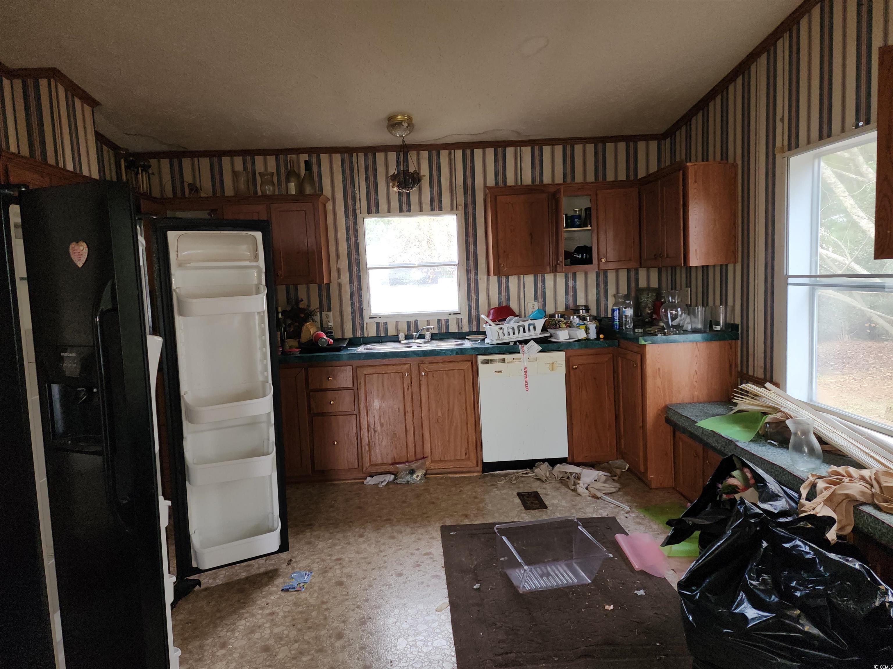 5160 Spring Street Loris, SC 29569 - Photo 17 of 18 Kitchen featuring black fridge with ice dispenser,