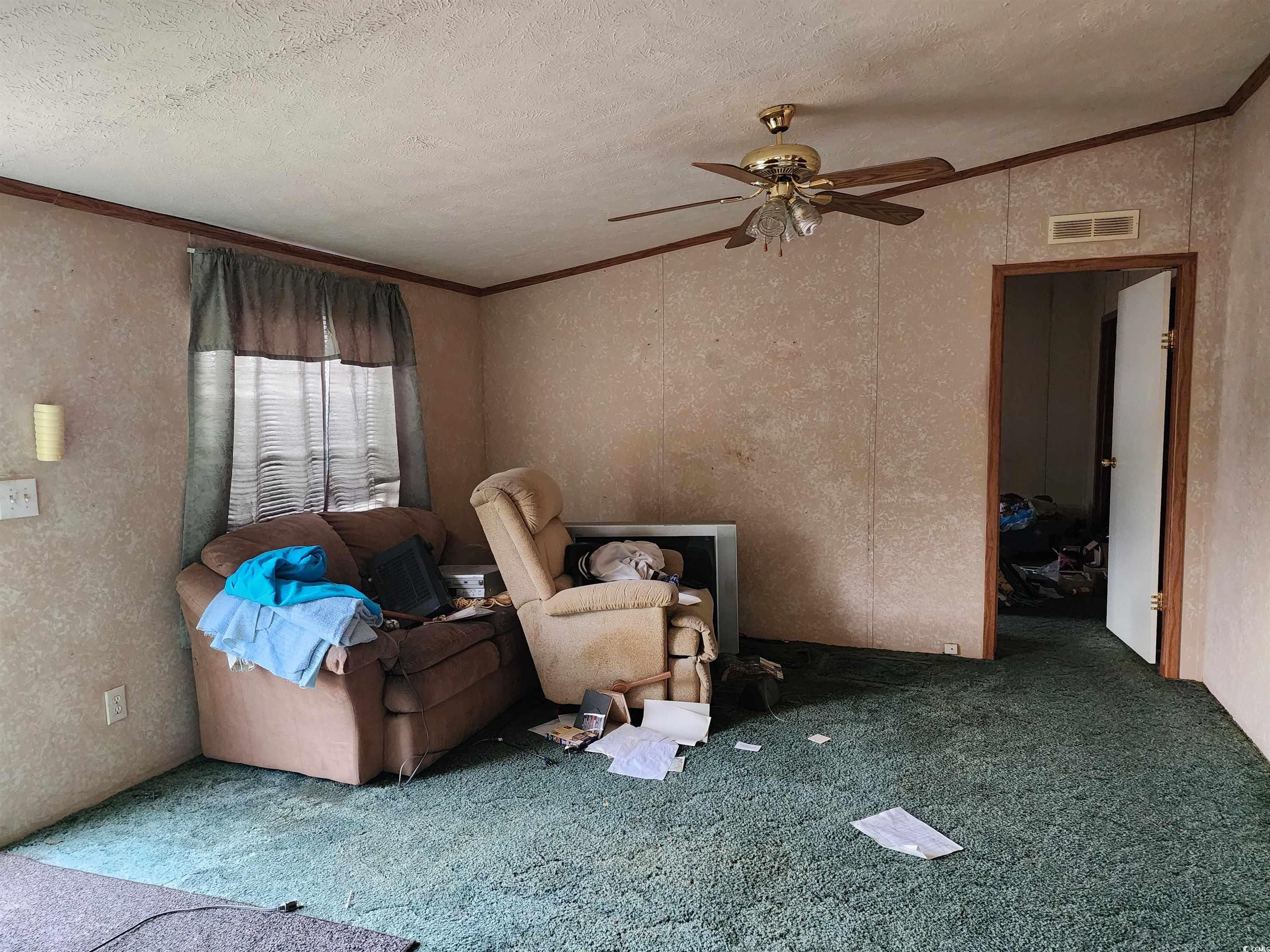 5160 Spring Street Loris, SC 29569 - Photo 10 of 18 Carpeted living room with ceiling fan, lofted ceil