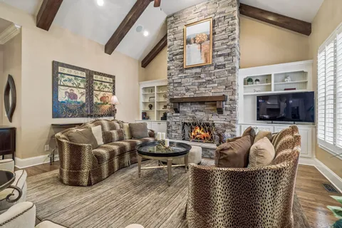 a living room with fireplace furniture and a flat screen tv