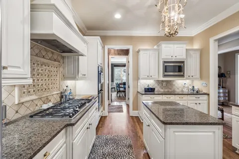 a kitchen with a stove sink and microwave