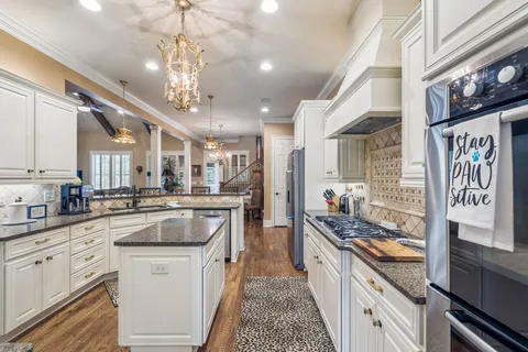 a kitchen with stainless steel appliances granite countertop a sink and stove