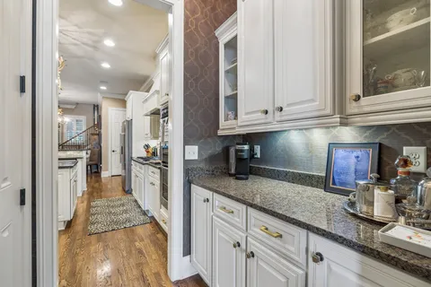 a kitchen with granite countertop a sink stainless steel appliances and cabinets