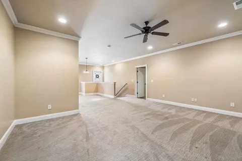 an empty room with a ceiling fan and window