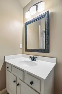 a bathroom with a sink vanity and a mirror