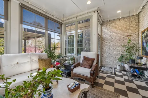 a living room filled with furniture and a potted plant