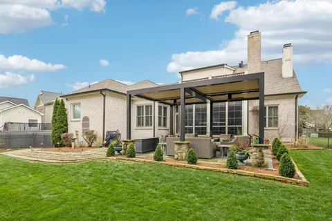 a front view of a house with garden and porch