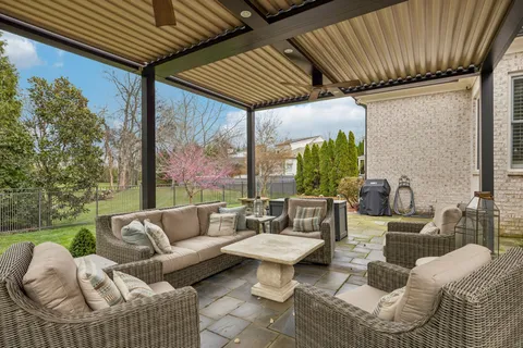 a patio with patio couch and outdoor seating