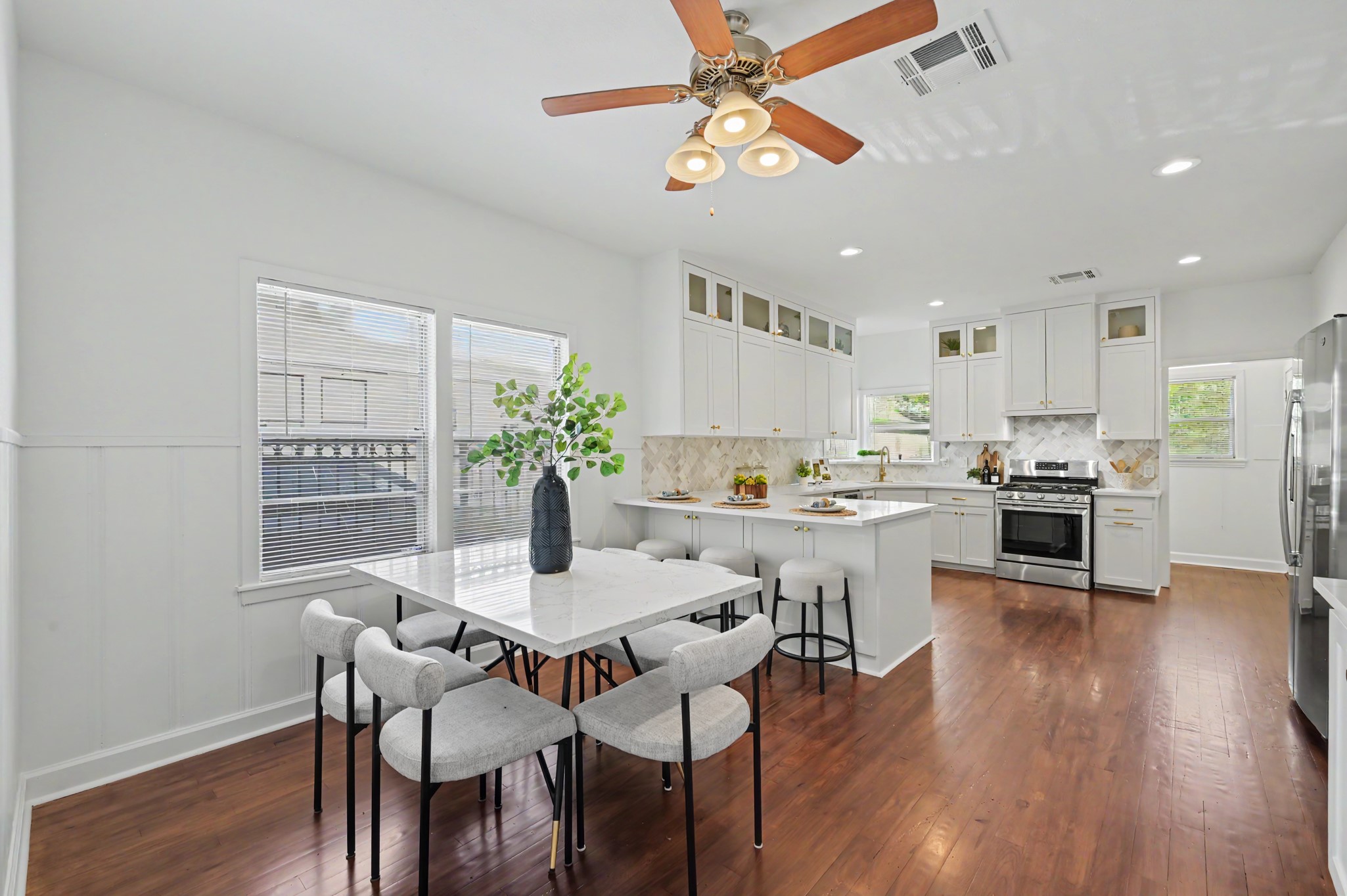 807 Key Street Houston, TX 77009 - Photo 11 of 27 Spacious kitchen and dining area featuring extensive cabinetry, a large peninsula with seating, and beautiful hardwood floors.