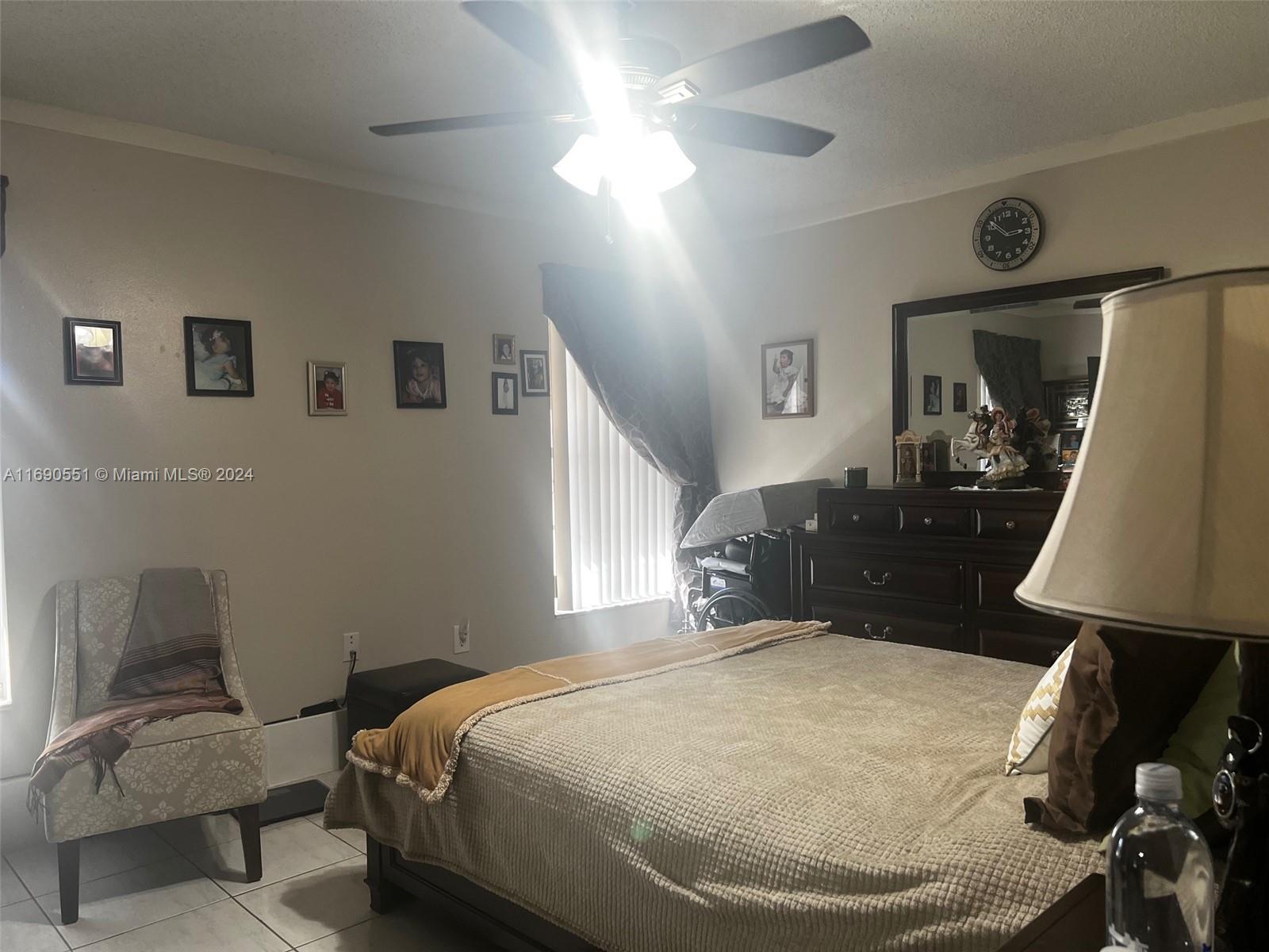 16331 Southwest 104th Avenue Miami, FL 33157 - Photo 11 of 23 a bed room with a bed and a lamp