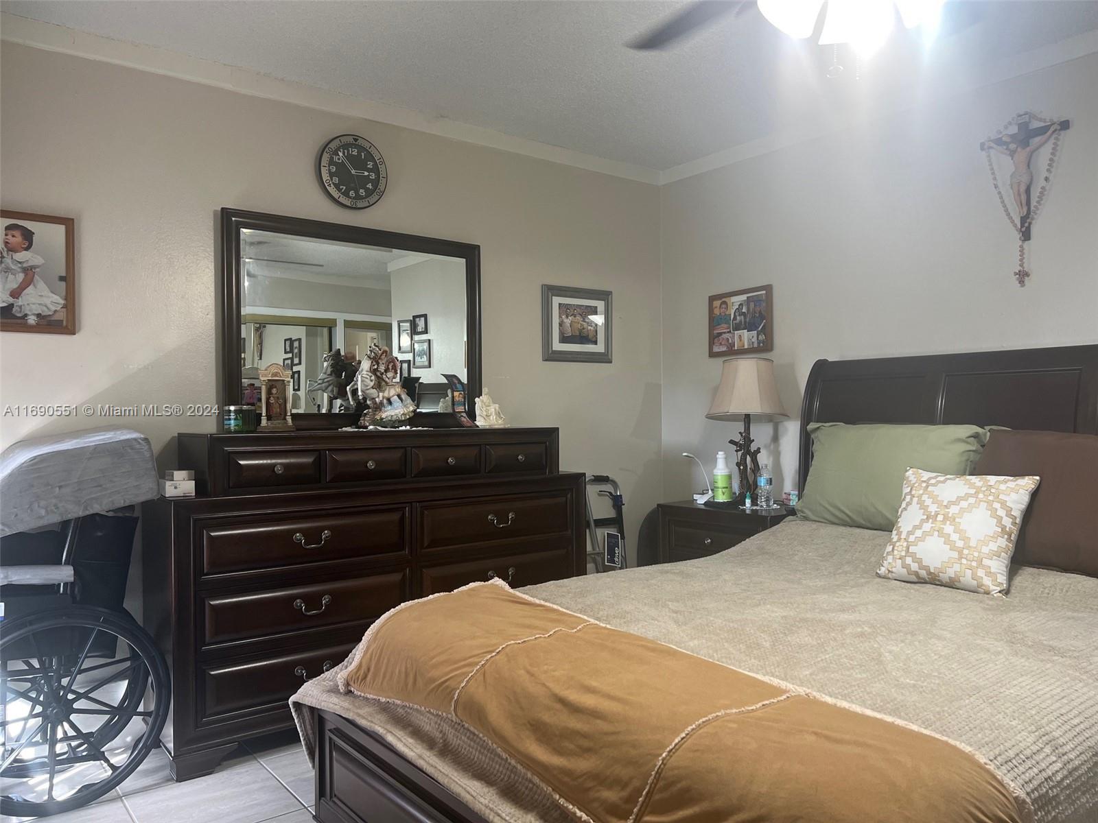 16331 Southwest 104th Avenue Miami, FL 33157 - Photo 12 of 23 a bedroom with a bed and a dresser
