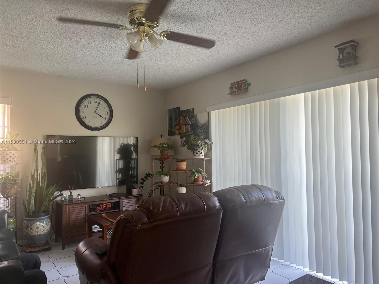 16331 Southwest 104th Avenue Miami, FL 33157 - Photo 16 of 23 a living room with furniture a clock and a window