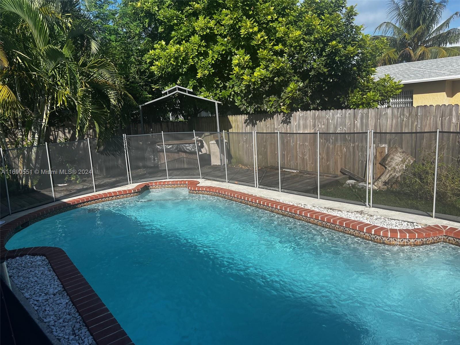 16331 Southwest 104th Avenue Miami, FL 33157 - Photo 21 of 23 a backyard of a house with swimming pool and deck