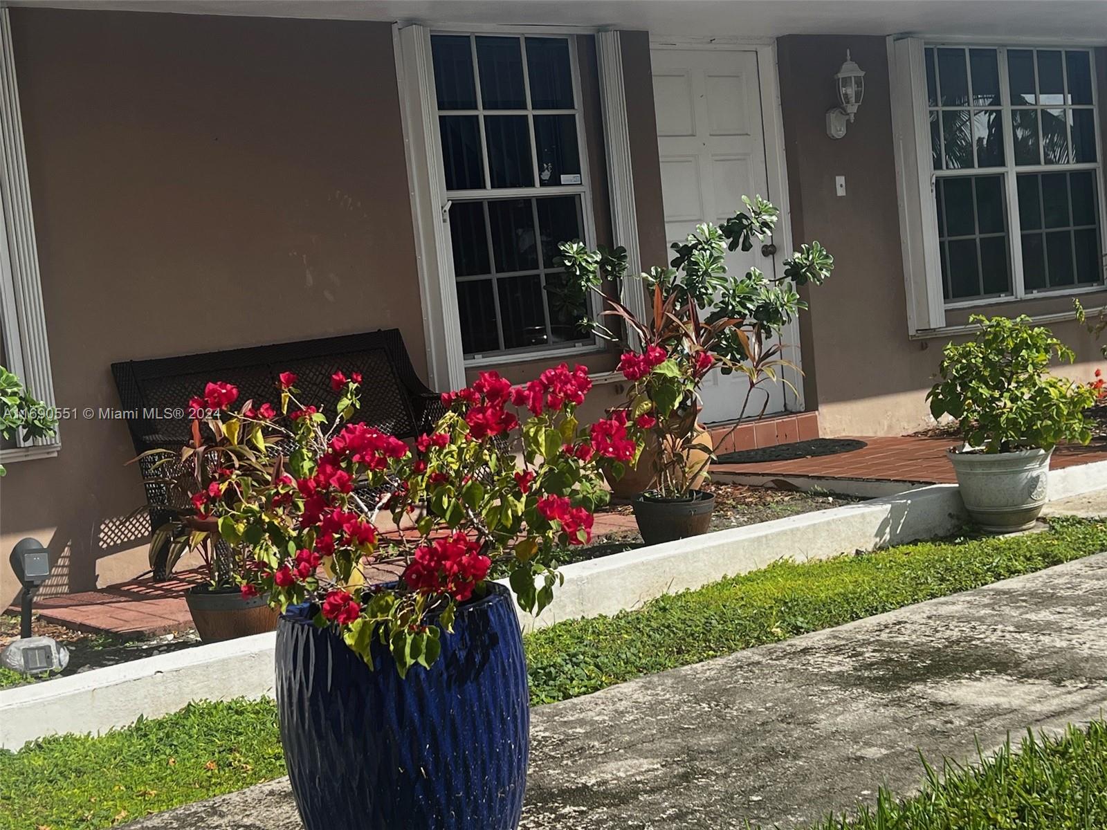 16331 Southwest 104th Avenue Miami, FL 33157 - Photo 4 of 23 a house with a flower garden in front of it