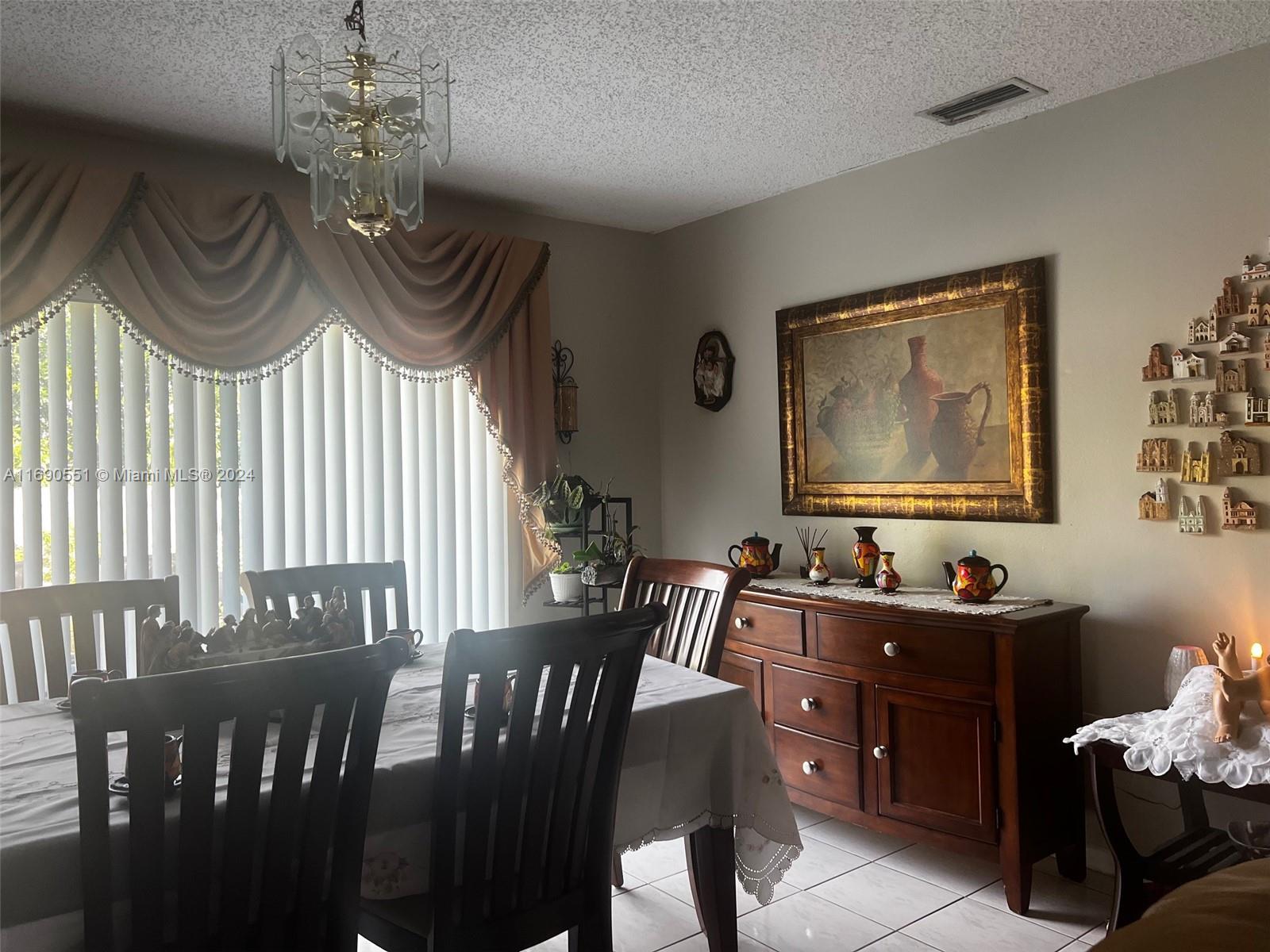 16331 Southwest 104th Avenue Miami, FL 33157 - Photo 8 of 23 a view of a dining room with furniture window and wooden floor