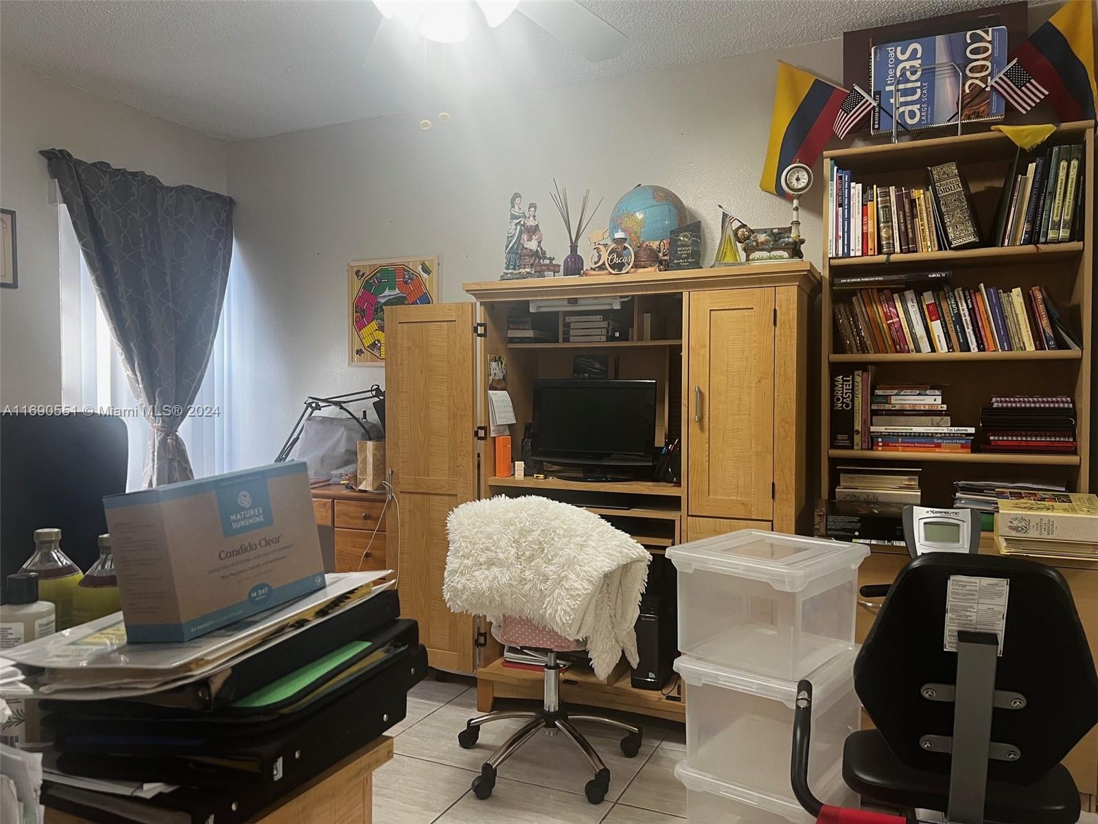 16331 Southwest 104th Avenue Miami, FL 33157 - Photo 10 of 23 a work room with furniture and a book shelf