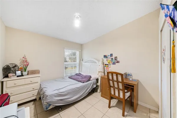 a bedroom with a bed and a dresser in it