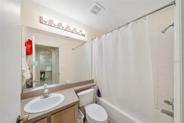 a bathroom with a toilet a sink and a mirror