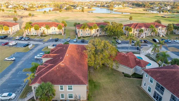 an aerial view of residential houses with outdoor space and ocean view