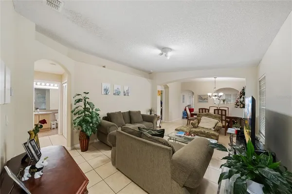 a living room with furniture and flowers