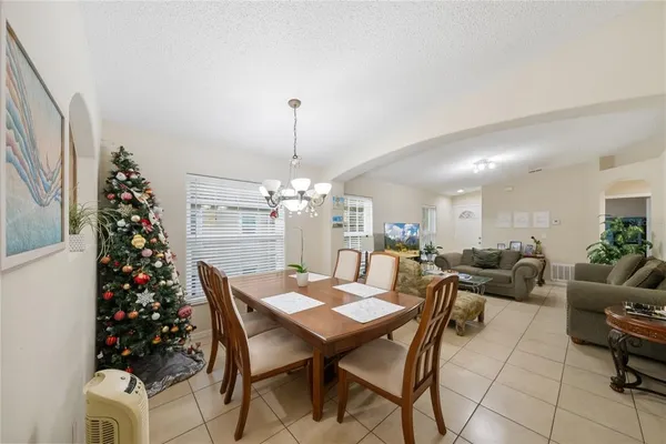 a view of a dining room with furniture and chandelier