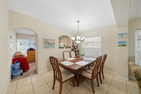 a view of a dining room with furniture and chandelier