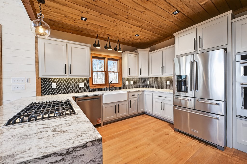 22 Mountain Trace Cherry Log, GA 30522 - Photo 14 of 49 a kitchen with a refrigerator and white cabinets