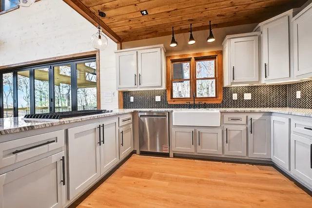 a kitchen with stainless steel appliances granite countertop a sink and cabinets